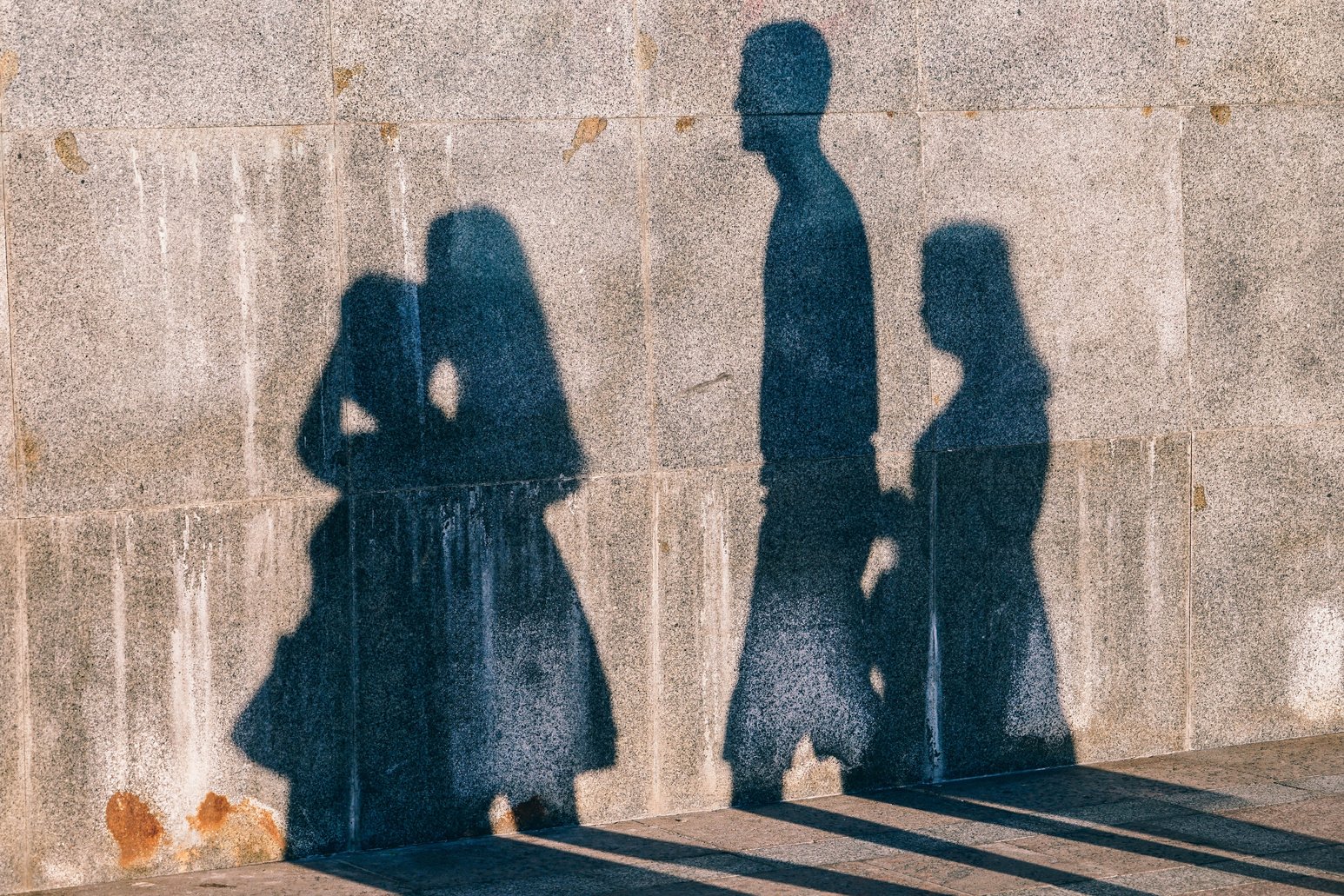 People Shadows on a Concrete Wall