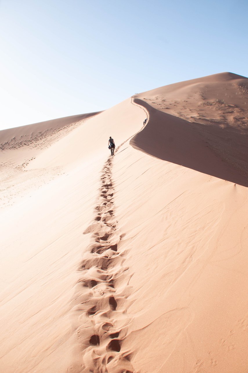 Person Walking on Sand